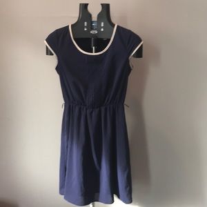 Navy blue dress with white trim.